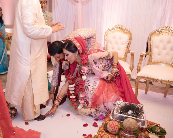  A pose capturing the couple receiving blessings from their elders, showcasing respect and love.