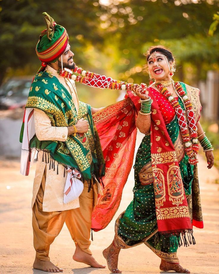 A pose where the couple is engaged in a traditional Maharashtrian dance, capturing the cultural essence of the wedding. 
