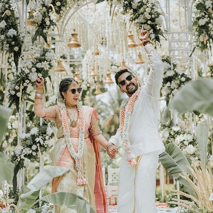 Photo of South Indian couple in colour-coordinated outfits on their wedding  day